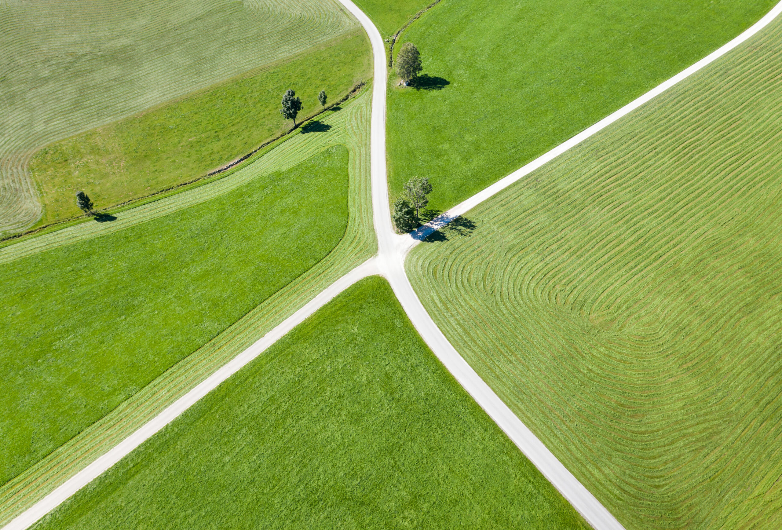 Aerial of Roads crossing with farm land on the side. 